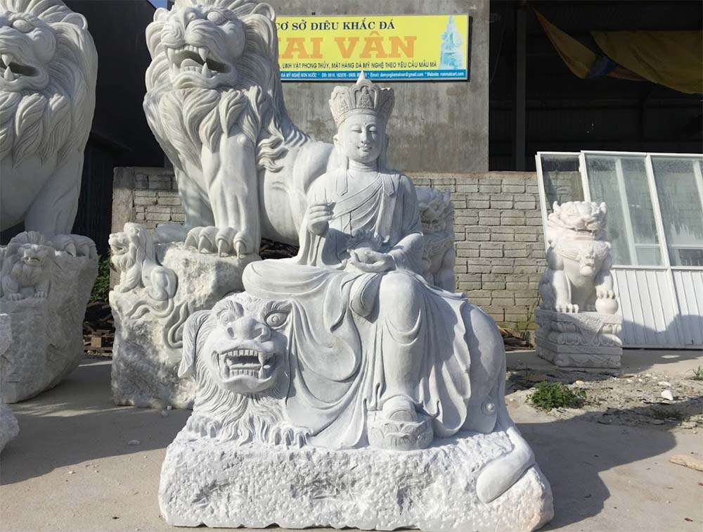 Intricately Carved Marble Statue of a Deity with Guardian Lions at Sculpture Workshop