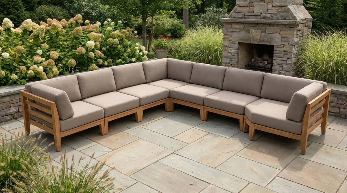 A set of three nesting tables arranged beside a garden chair, with one table extended for use. The tables feature weather-resistant finishes like powder-coated metal or sealed teak, demonstrating space-efficient surface area for entertaining in a cozy outdoor space.