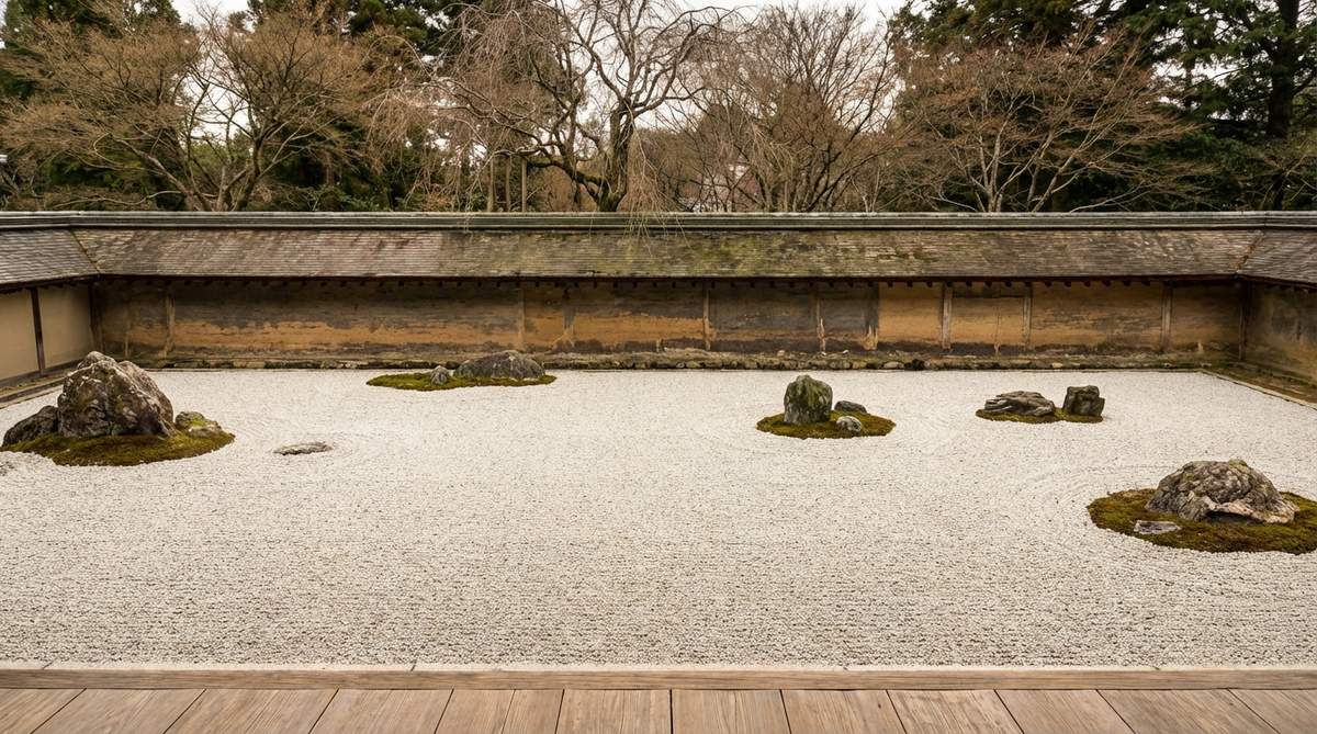 A view of the fifteen stone arrangement at Ryoanji Temple in Kyoto, Japan, illustrating the famous perceptual puzzle where no single vantage point reveals all stones simultaneously. The carefully positioned stone groups create an optical challenge that teaches about perspective limitations and the nature of partial knowledge in Japanese stone garden design.