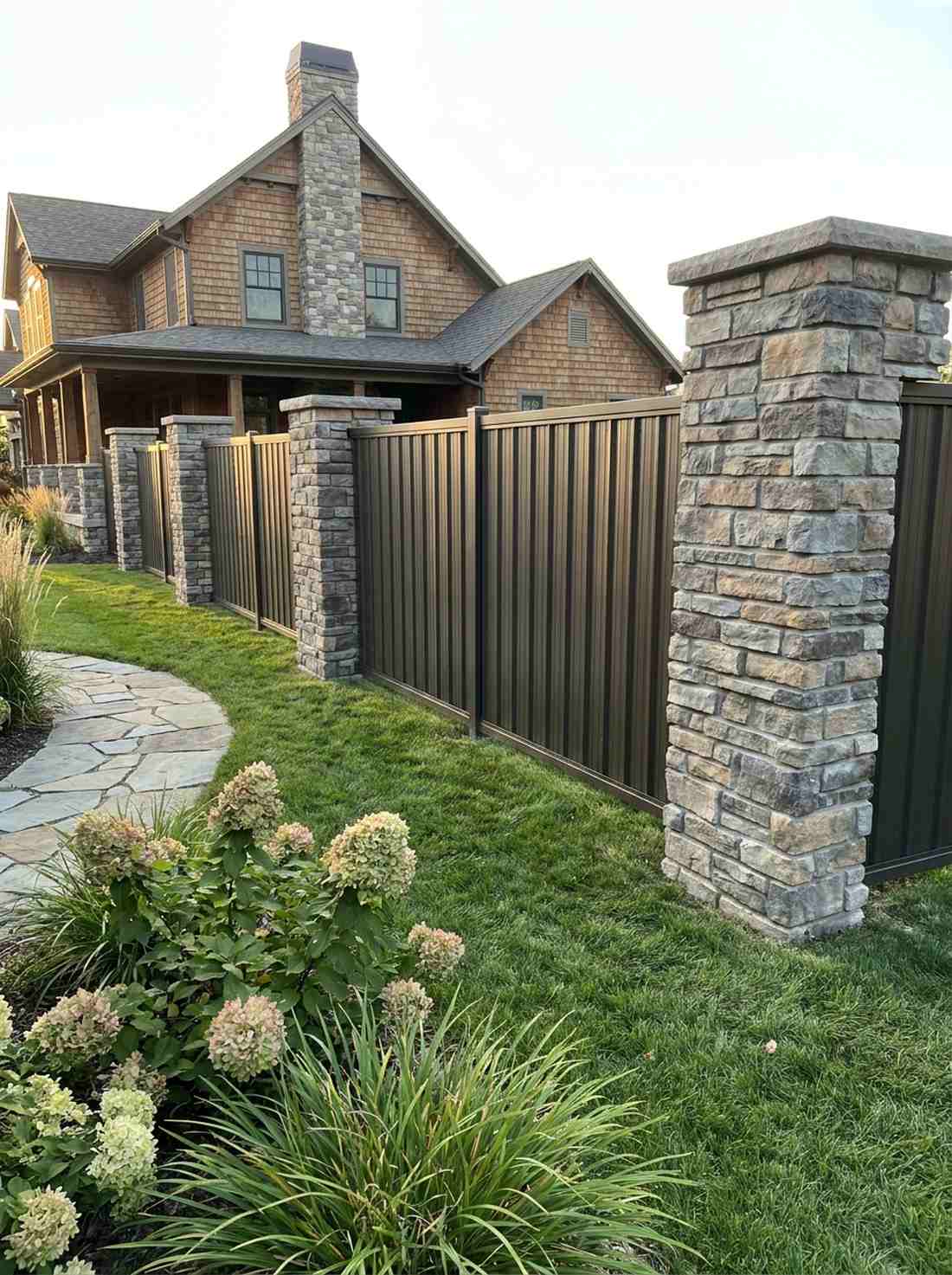 stone pillar and metal panel fence